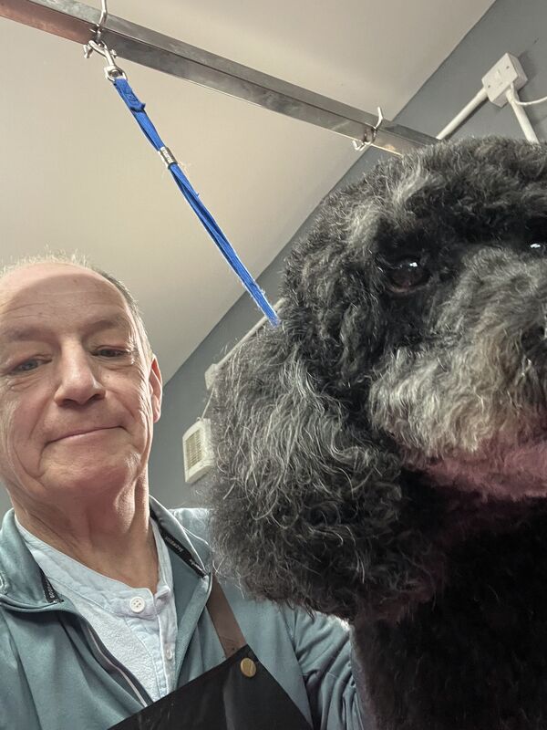 Keith with a grey schnauzer.